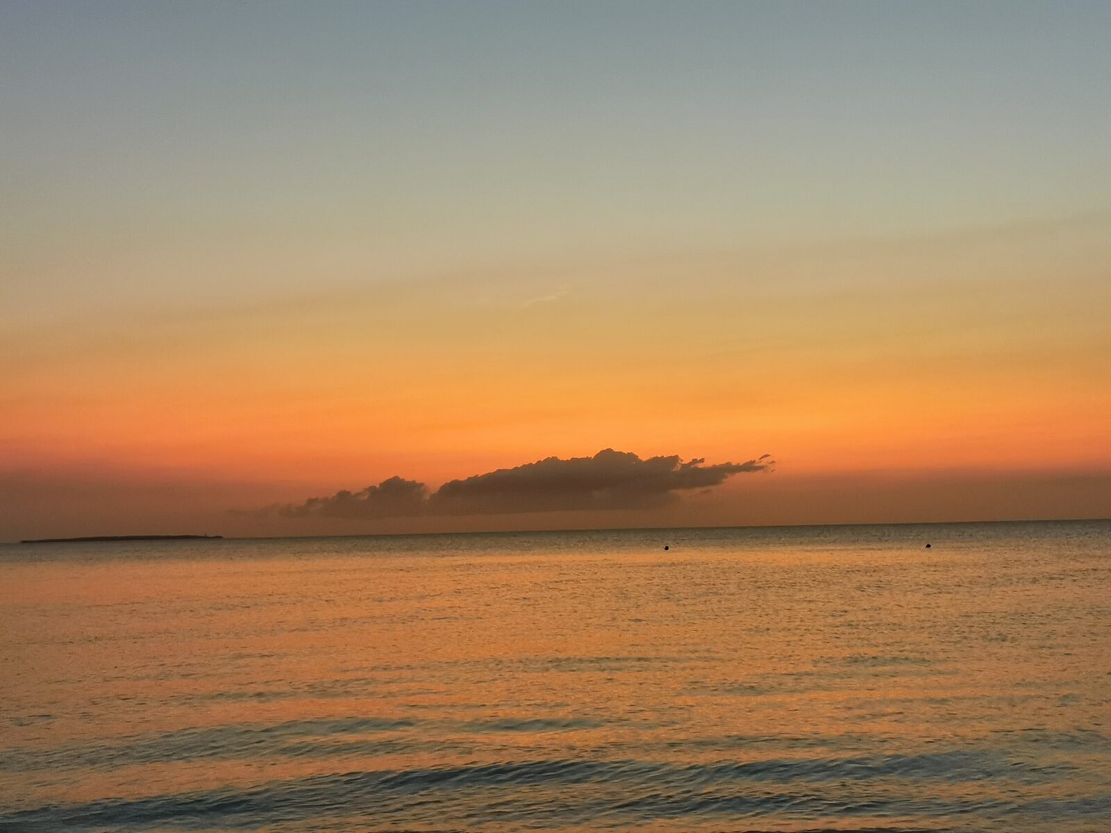 Orange sunset glowing over a calm Zanzibar sea