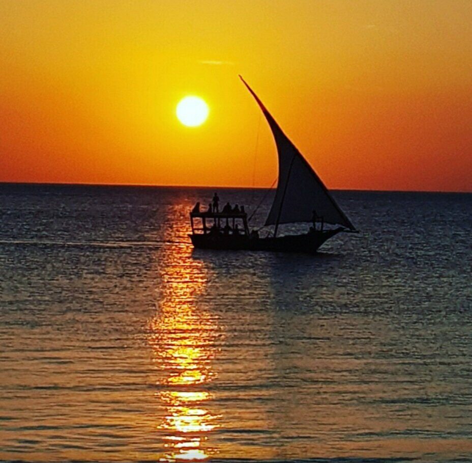 Dhow silhouette against a glowing Zanzibar ocean sunset
