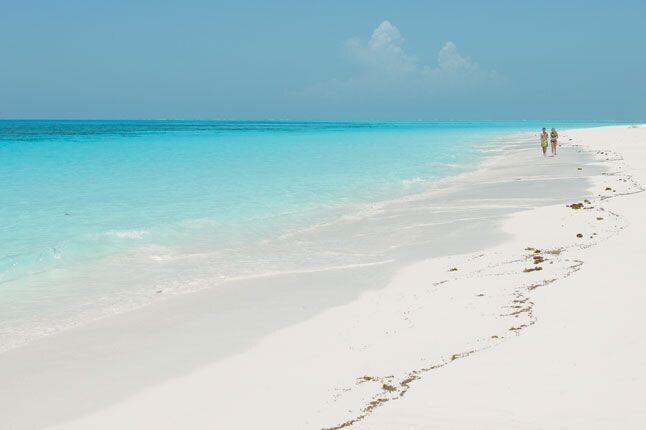An empty white-sand beach and turquoise sea