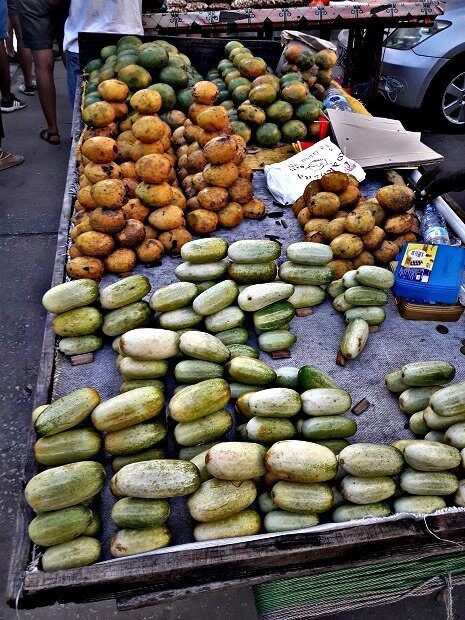 Produce stall with cucumbers and papaya at Darajani market