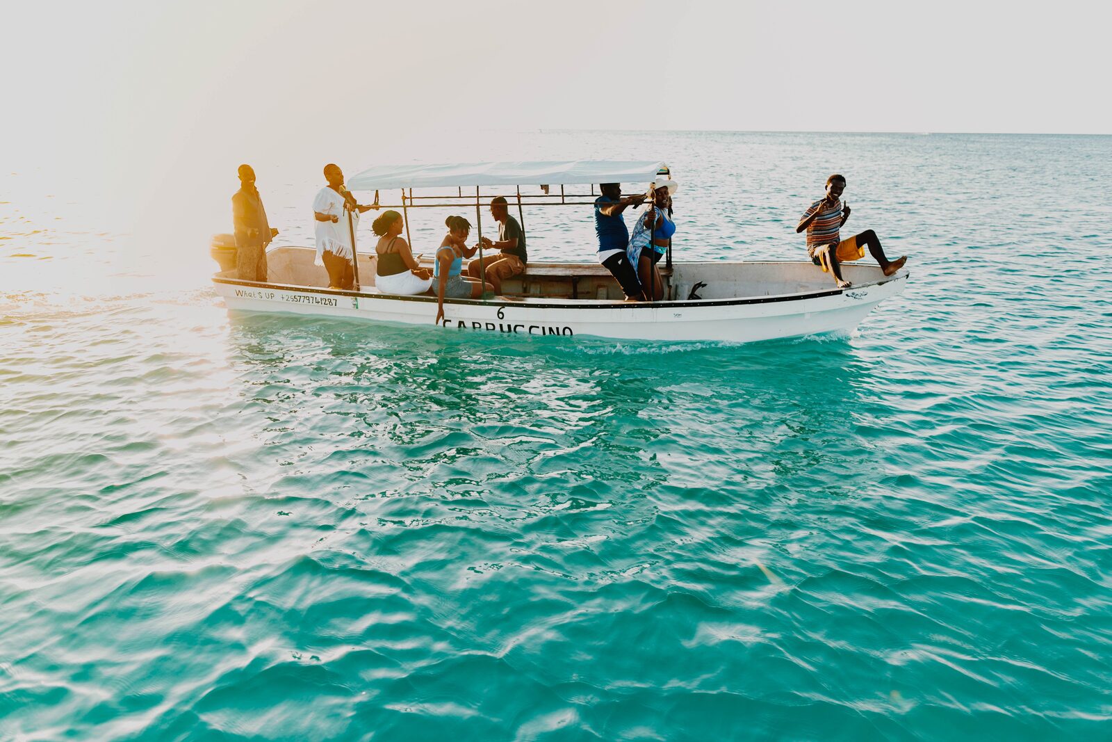 Tour group aboard a small boat on the Zanzibar sea