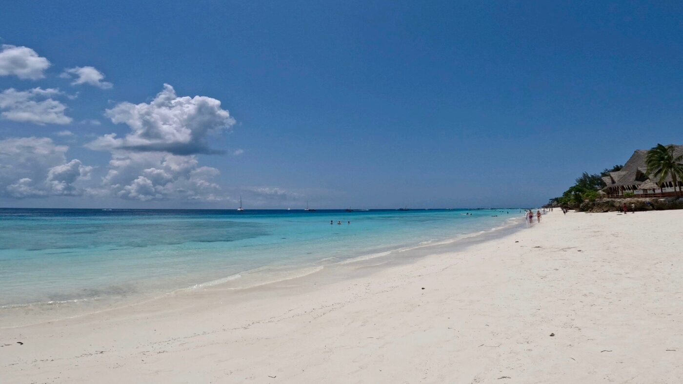A wide beach under dry-season skies